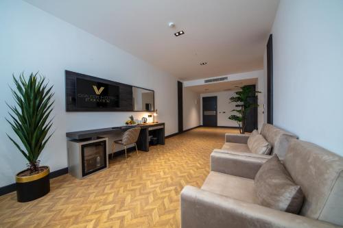 a living room with a couch and a fireplace at V Center Hotel in Trabzon