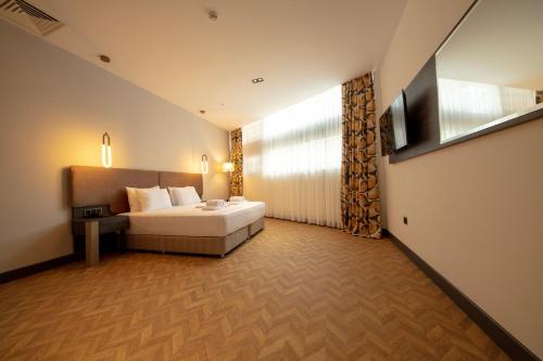 a hotel room with a bed and a window at V Center Hotel in Trabzon