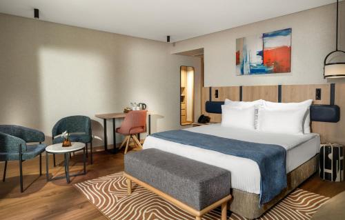 a hotel room with a bed and a table and chairs at Elite World Kuşadası in Kusadası