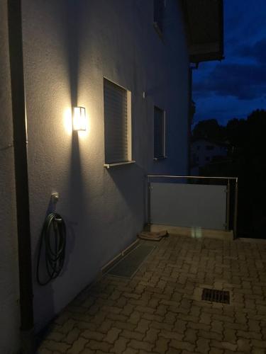 a light on the side of a building at night at Home Maislinger - Enjoy Nature, Explore Salzburg in Wals