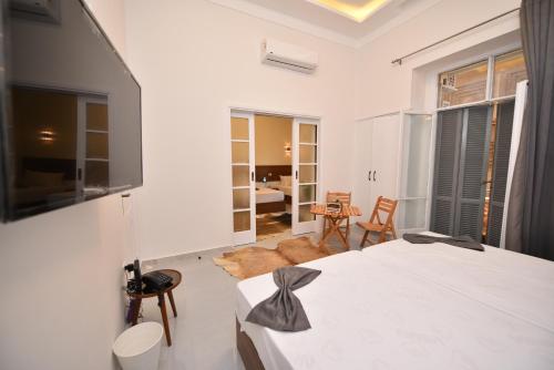 a bedroom with a bed and a living room at family suites cairo downtown in Cairo