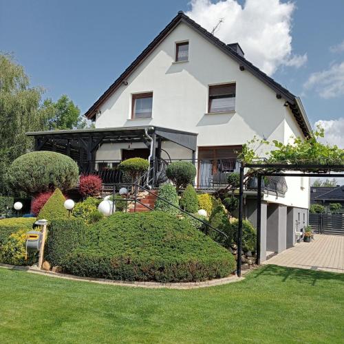 a large white house with a green yard at Eliza noclegi in Bolesławiec