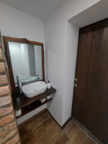 a bathroom with a sink and a mirror at Belvárosi apartmanház 2, Apartman 3 in Szigetvár