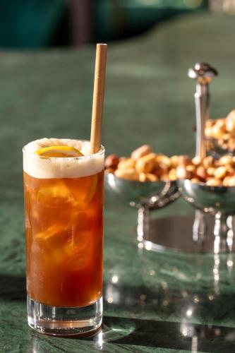 a drink with a stick in it sitting on a table at Elite World Kuşadası in Kusadası