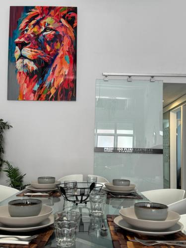 a dining room table with a painting of a lion at Dream Loft Sc in Santa Cruz de Tenerife