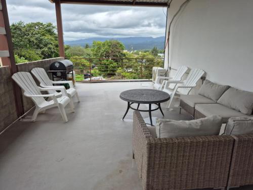 a patio with a couch and chairs and a table at Aparta hotel Carmela#1 in Siguatepeque