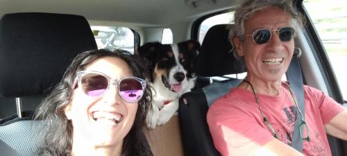two women and a dog sitting in the back of a car at Casale Artemisia Capalbio in Capalbio