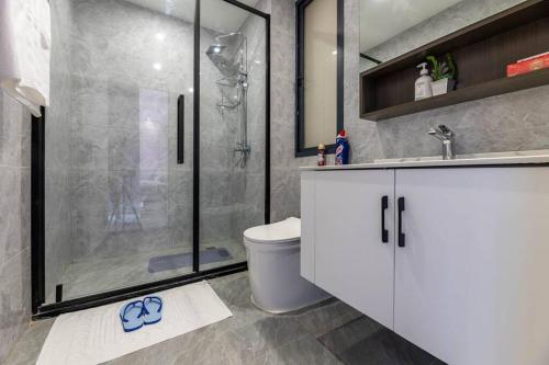 a bathroom with a shower and a toilet and a sink at Kilimani Premier 1BR in Nairobi