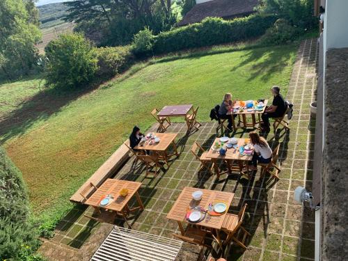 a group of people sitting at tables on a patio at Casale Artemisia Capalbio in Capalbio