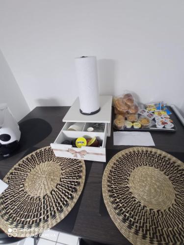 a table with two plates and a box of donuts at Victor's Room in Cetara