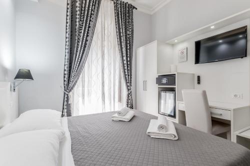 a bedroom with a bed with two towels on it at Vatican Sweet Guest House in Rome