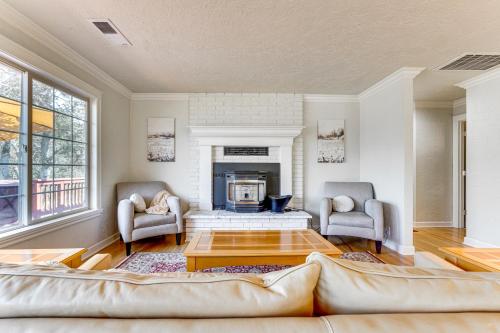 a living room with a couch and a fireplace at 8 Mi to Jacksonville Oregon Getaway with Deck! in Jacksonville