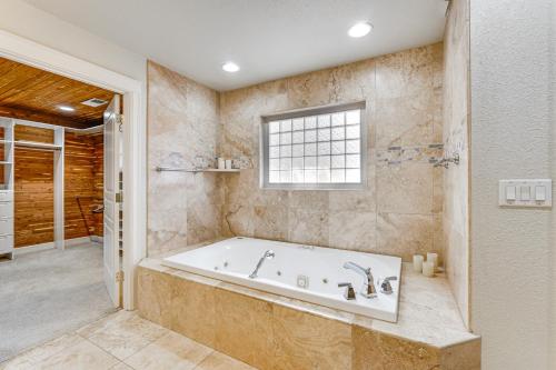a large bathroom with a tub and a window at 8 Mi to Jacksonville Oregon Getaway with Deck! in Jacksonville