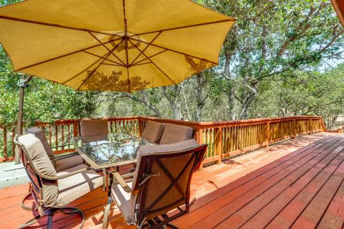 a table and chairs on a deck with an umbrella at 8 Mi to Jacksonville Oregon Getaway with Deck! in Jacksonville