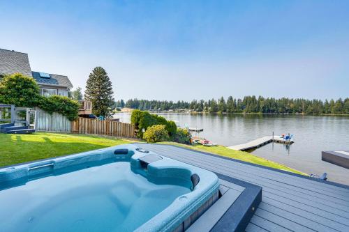a swimming pool on a deck next to a body of water at The Rookery - Dreamy Home with Private Dock! in Yelm