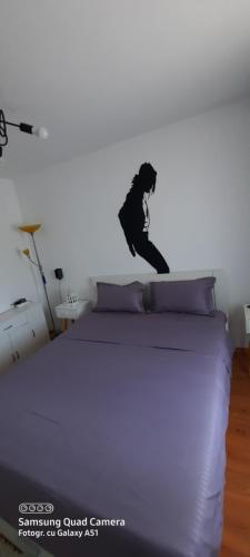 a woman jumping on a bed in a bedroom at Serghi in Mangalia