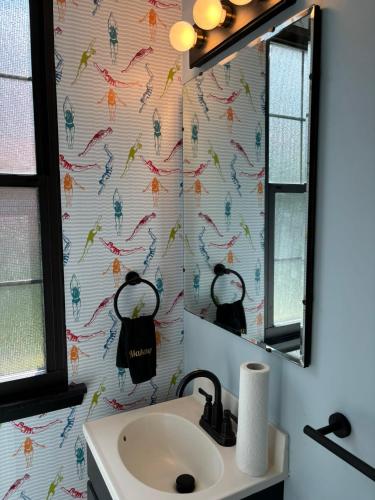a bathroom with a sink and a mirror at Welcome to Camp Sycamore in Pittsburgh
