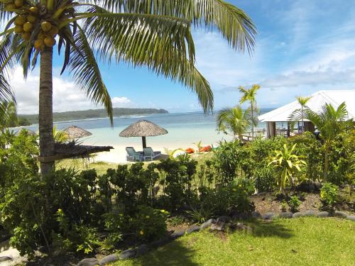 a view of a beach with a palm tree at Savaii Lagoon Resort in Fagamalo