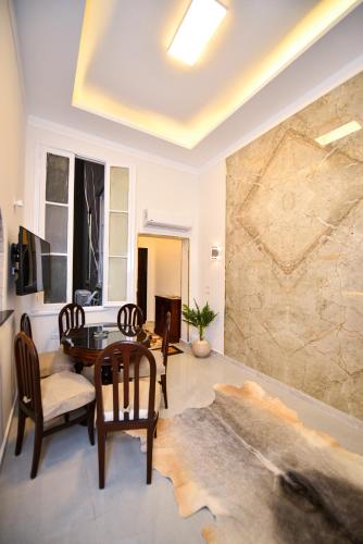 a living room with a table and a stone wall at family suites cairo downtown in Cairo