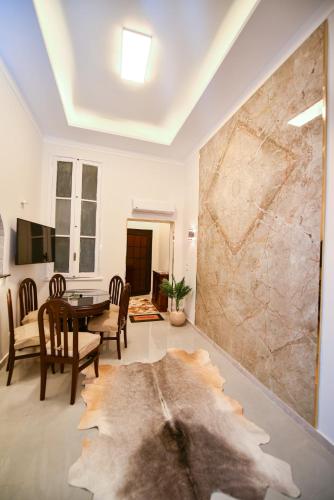 a living room with a table and a stone wall at family suites cairo downtown in Cairo