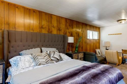 a bedroom with a large bed and wooden walls at A Quiet Escape in Arnold