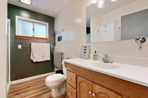 a bathroom with a sink and a toilet and a mirror at A Quiet Escape in Arnold