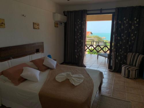 Ένα ή περισσότερα κρεβάτια σε δωμάτιο στο Pousada Villa Flamboyant