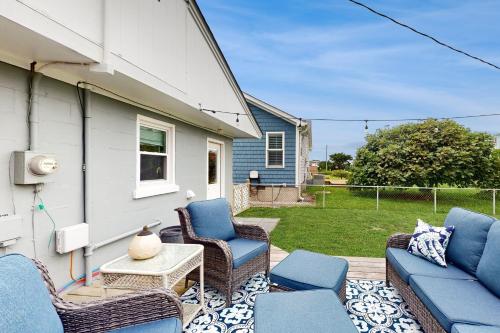 a patio with chairs and a couch and a table at Miller Time in Atlantic Beach