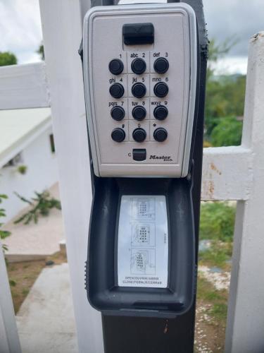 a parking meter sitting next to a white fence at Casa Motmot Guanacaste in Puerto Viejo