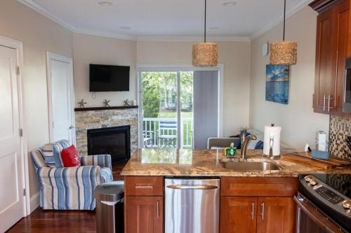 a kitchen with a sink and a living room at The East Island Reserve Hotel in Middletown