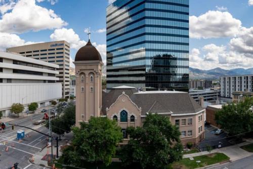 a building with a clock tower in a city at Modern dntwn apt- prime location in Salt Lake City