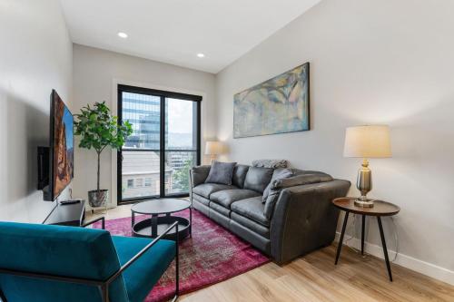 a living room with a couch and a table at Prime location - downtown SLC apt - ALL NEW in Salt Lake City