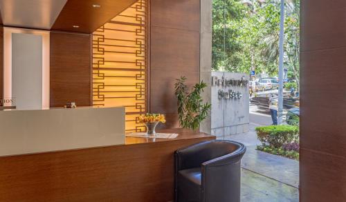 a bar with a black chair in front of a building at Britannia Suites in Beirut