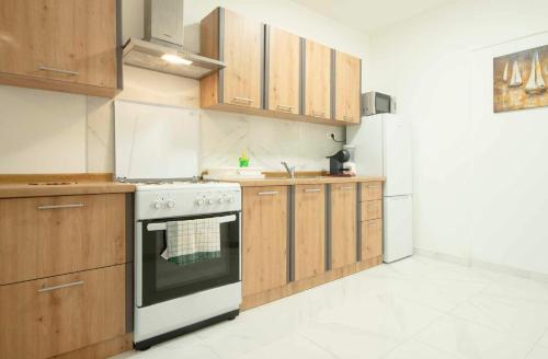 a kitchen with wooden cabinets and a stove at Apartment Nina in Slunj