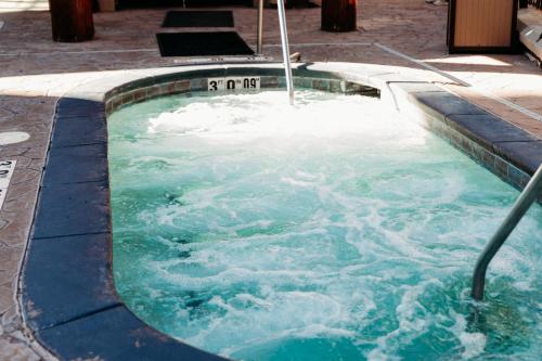 a hot tub filled with water with an umbrella at Ski-in-out, Canyons, Westgate, King, Breakfast, HT in Park City
