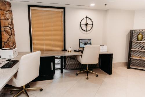 an office with a desk and two chairs and a clock at Ski-in-out, Canyons, Westgate, King, Breakfast, HT in Park City