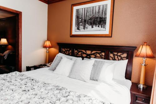 a bedroom with a white bed with a picture on the wall at Ski-in-out, Canyons, Westgate, King, Breakfast, HT in Park City