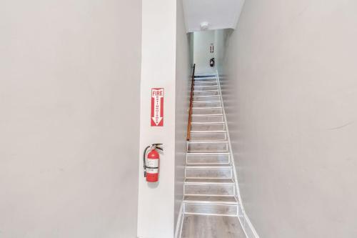 a stair case with a fire extinguisher and a ladder at Trolley Teacup Charming Cozy Studio apts in Wilmington