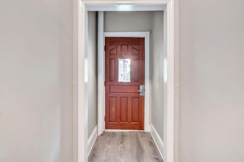 an empty corridor with a brown door in a room at Trolley Teacup Charming Cozy Studio apts in Wilmington