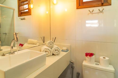 a bathroom with a sink and a toilet and a mirror at Casa Suiça Brasileira in Jericoacoara