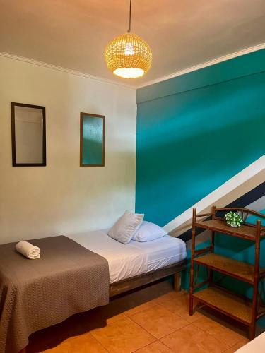 a room with a bed and a table and a lamp at Point Break Santa Teresa in Santa Teresa Beach