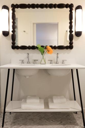 a bathroom with two sinks and a mirror at Winslow's Bungalows - Key West Historic Inns in Key West