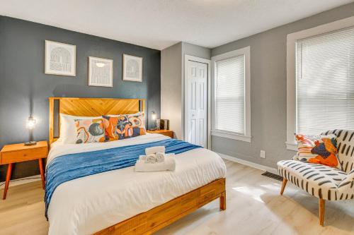 a bedroom with a large bed and a chair at University of Akron Retreat Dogs Welcome! in Akron
