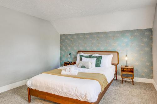 a bedroom with a large bed with a blue wall at University of Akron Retreat Dogs Welcome! in Akron
