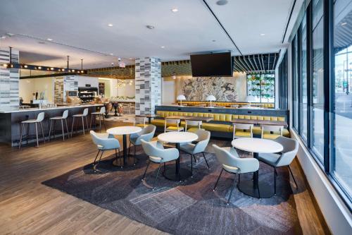 a restaurant with tables and chairs and a bar at DoubleTree by Hilton Hartford Downtown in Hartford