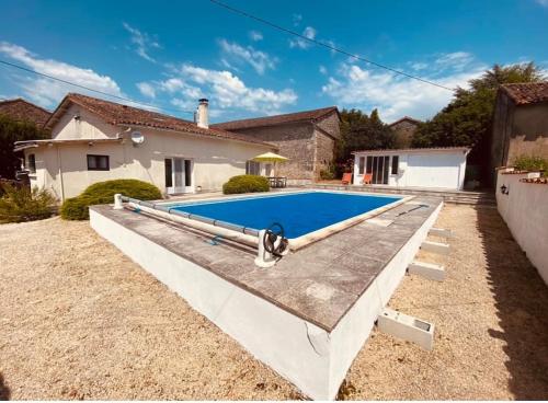 a swimming pool in the backyard of a house at 4 bed home with private pool in Génouillé
