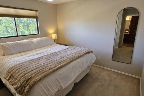 a bedroom with a large bed and a mirror at Cliff Views - Hot Tub - SUPs - Boat Parking - Sleeps 16 in Page