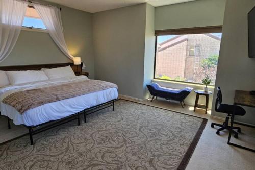 a bedroom with a large bed and a large window at Cliff Views - Hot Tub - SUPs - Boat Parking - Sleeps 16 in Page