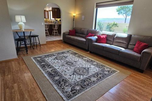 a living room with a couch and a rug at Cliff Views - Hot Tub - SUPs - Boat Parking - Sleeps 16 in Page