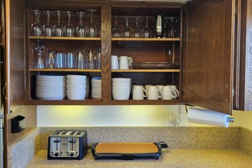 a kitchen counter with a toaster and plates and glasses at Cliff Views - Hot Tub - SUPs - Boat Parking - Sleeps 16 in Page